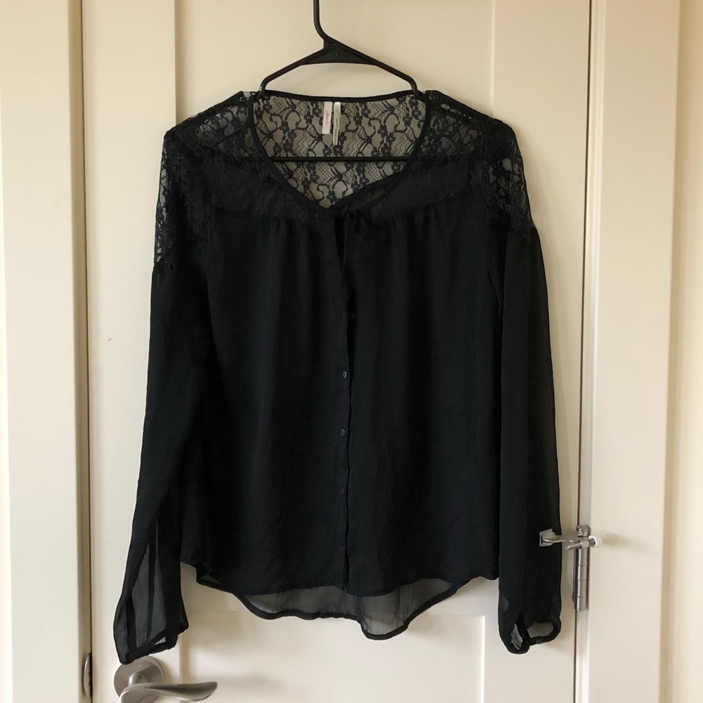 Flowy black blouse with sheer lace cutouts